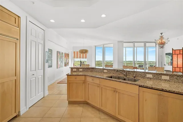 a large white kitchen with a large window