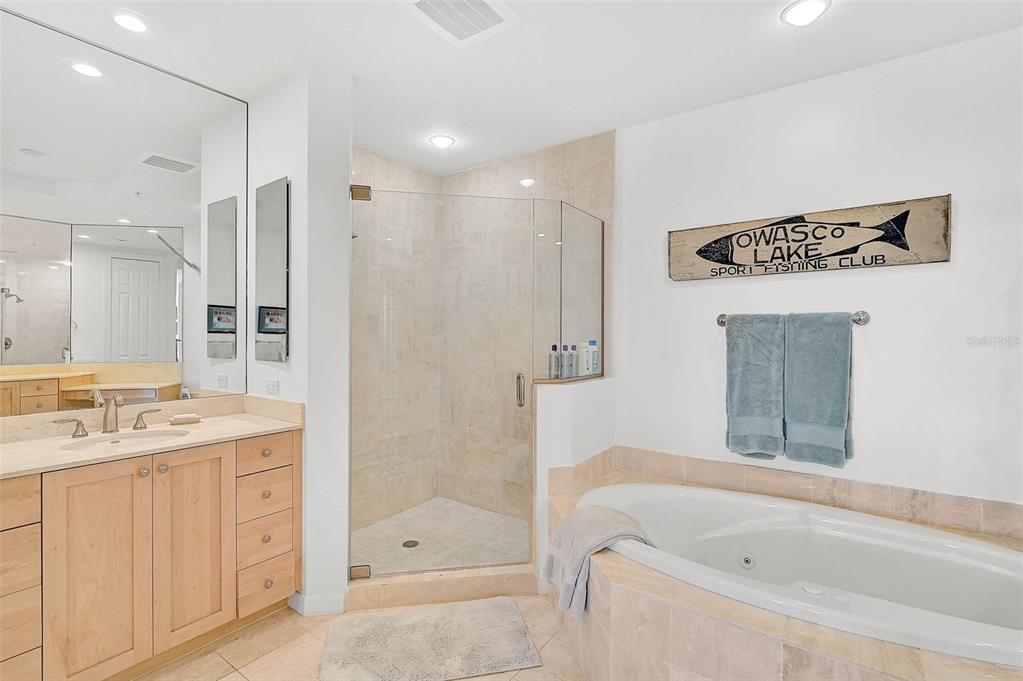 3603 North Point Road, Unit 702 Osprey, FL 34229 - Photo 19 of 61 a bathroom with a shower a sink and a bathtub