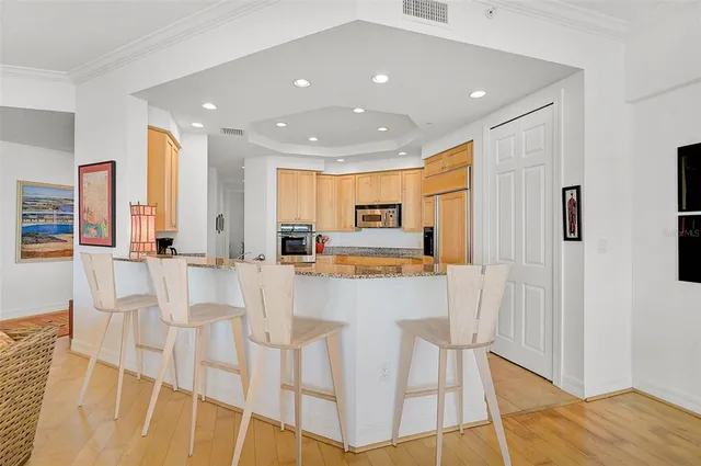 a view of kitchen with stainless steel appliances refrigerator microwave and cabinets