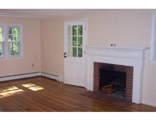 11 Prospect Road Andover, MA 01810 - Photo 2 of 4 a view of an empty room with wooden floor and a fireplace