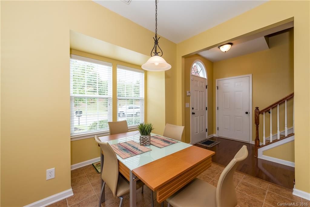 717 Prospect Lane, Unit 46 Fort Mill, SC 29708 - Photo 3 of 19 a living room with a table chairs and a chandelier