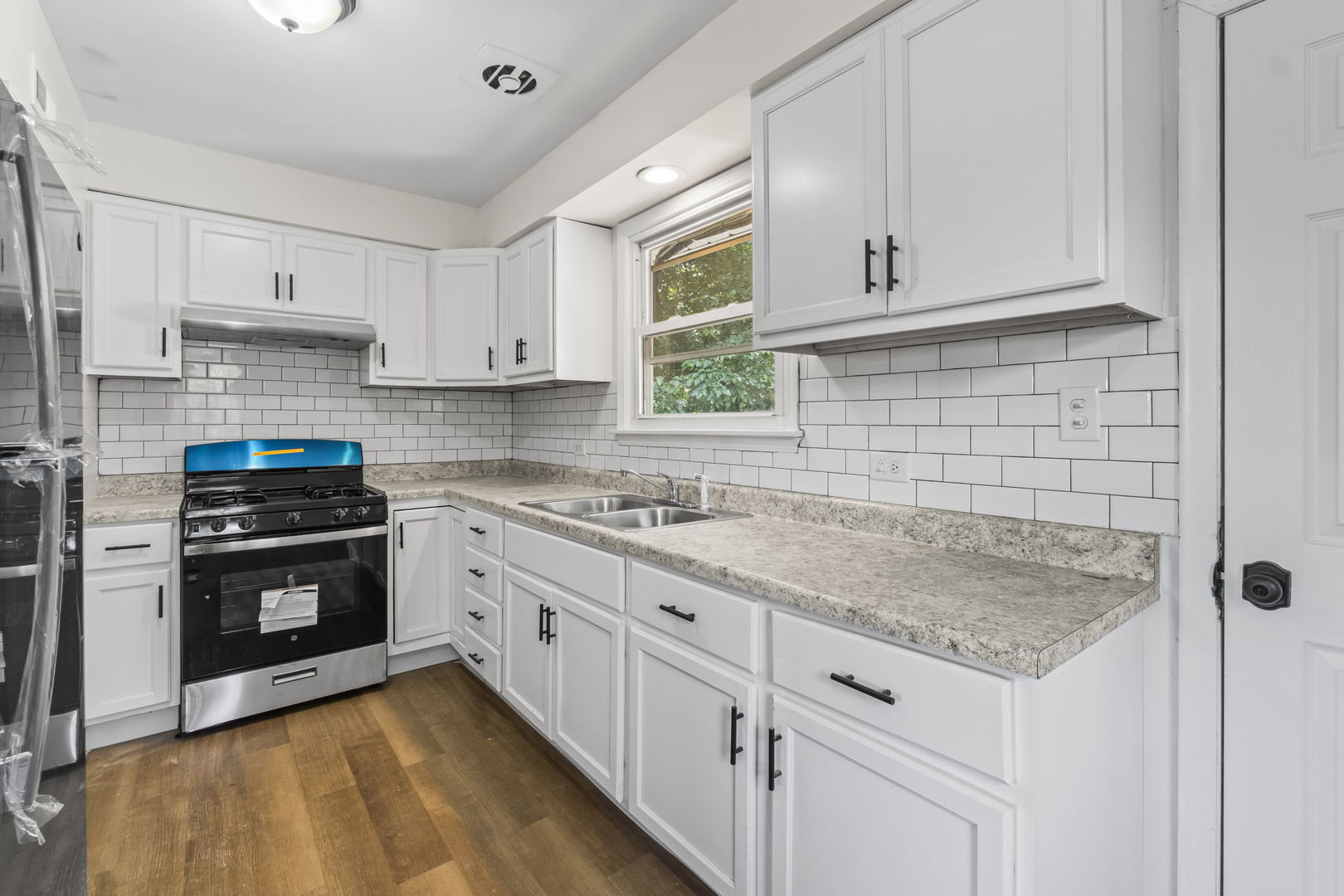 16608 Sawyer Avenue Markham, IL 60428 - Photo 7 of 19 a kitchen with granite countertop white cabinets and stainless steel appliances