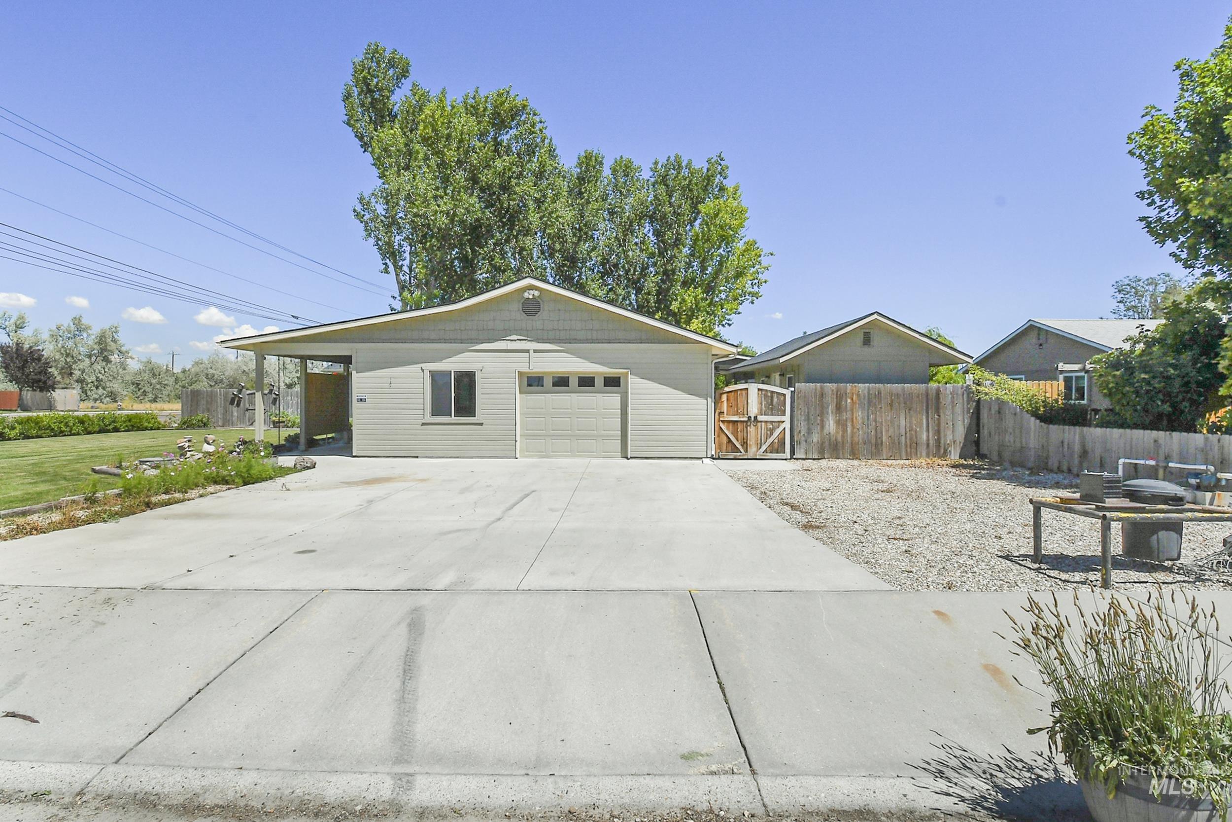 1108 East Ustick Road Caldwell, ID 83607 - Photo 2 of 30 Single-story residence featuring light gray siding and a light gray garage door with window inserts