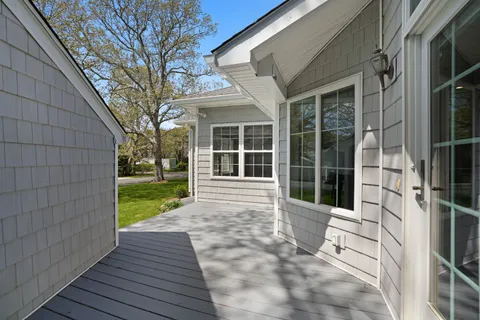 a front view of a house with a garden and trees