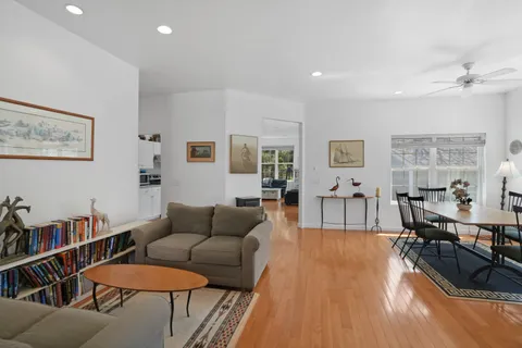 a living room with furniture and a white wall