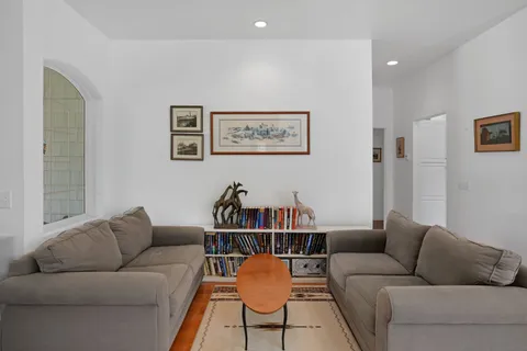 a dining room with furniture window and wooden floor