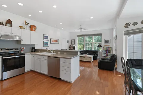 a kitchen with counter top space and wooden floor