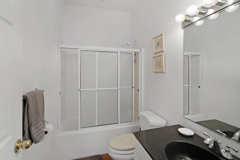 a bedroom with a bed and a desk