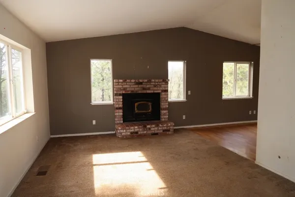 a view of livingroom with fireplace and window