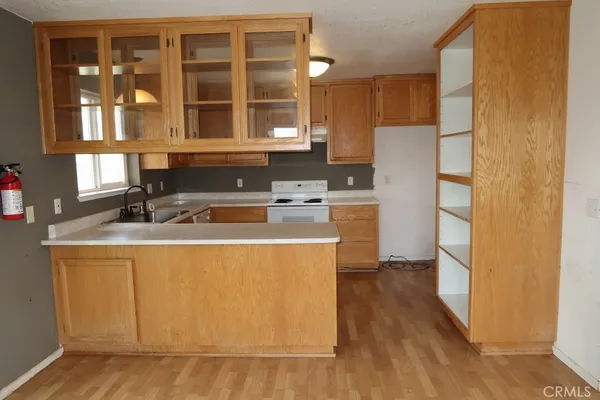 a kitchen that has a sink a stove and a microwave