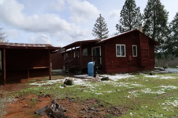 a backyard of a house with table and chairs