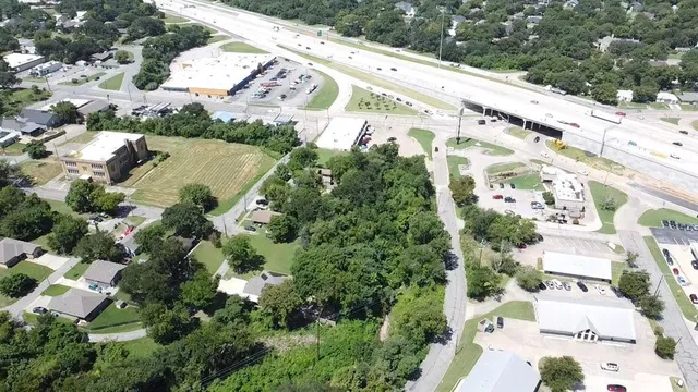 a view of a large building with a garden and plants