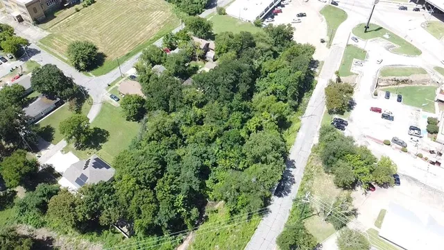 an aerial view of a house with a yard and flowers