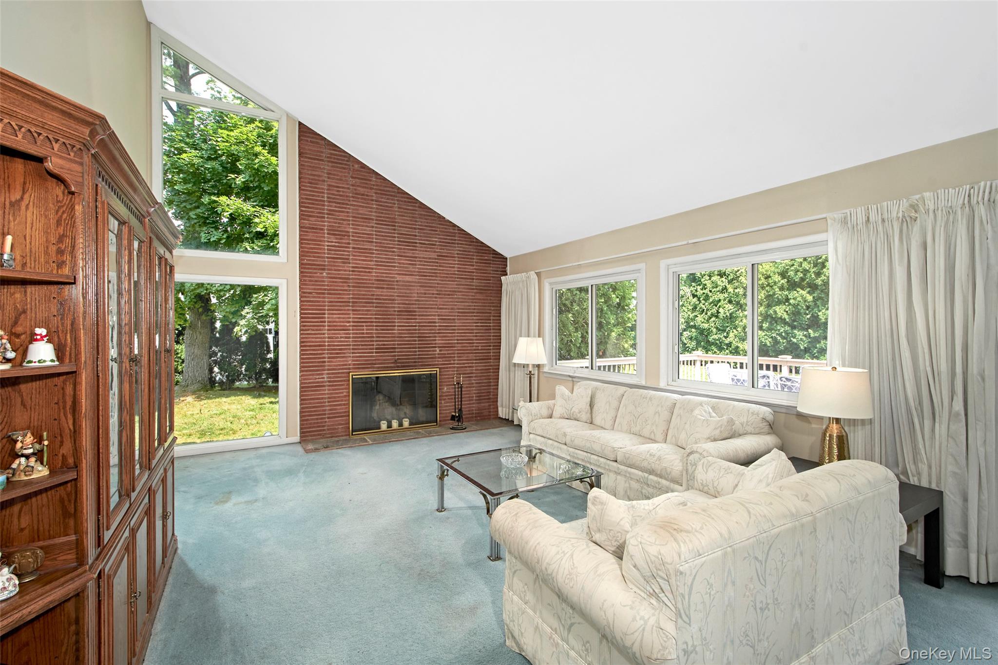 3 Bonwit Road Rye Brook, NY 10573 - Photo 8 of 31 Expansive open concept space with vaulted ceiling, floor to ceiling window and wood burning fireplace