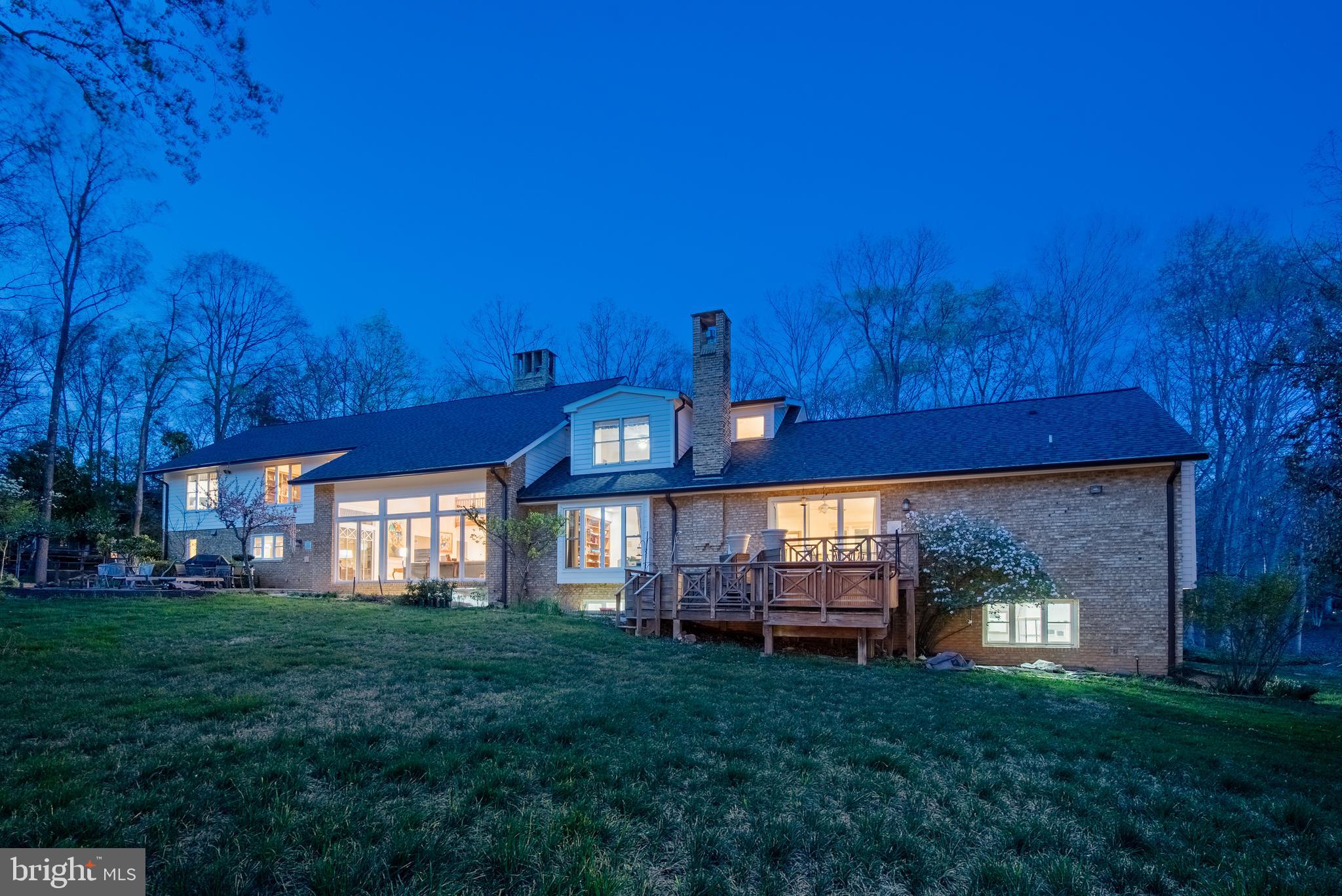 10100 Iron Gate Road Potomac, MD 20854 - Photo 6 of 16 a view of a house with a yard fire pit and outdoor seating