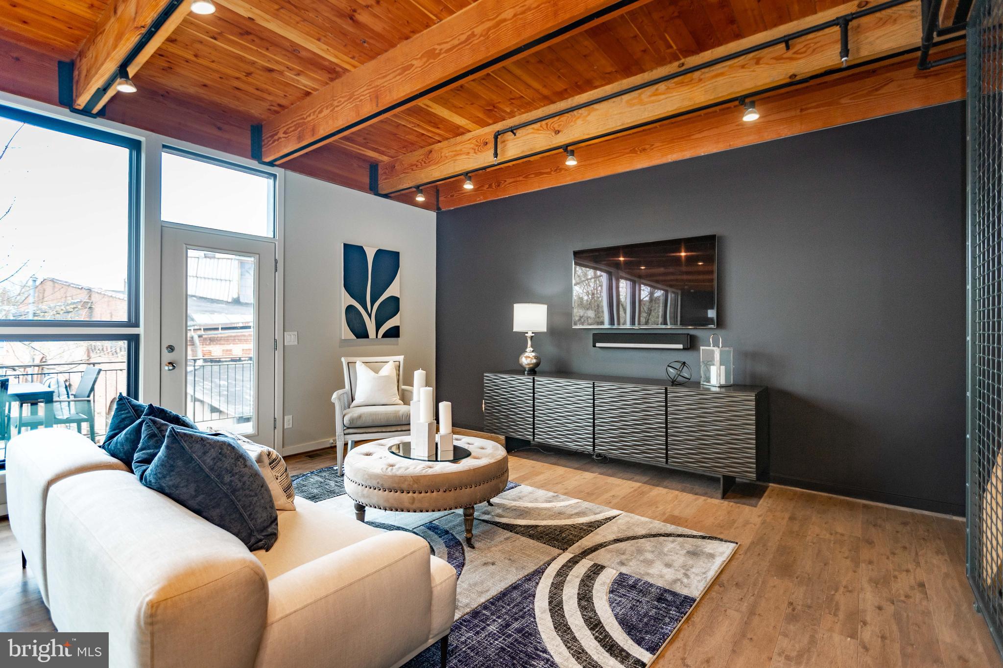 2074 Eric Shaefer Way Baltimore, MD 21211 - Photo 11 of 56 a living room with furniture and a wooden floor