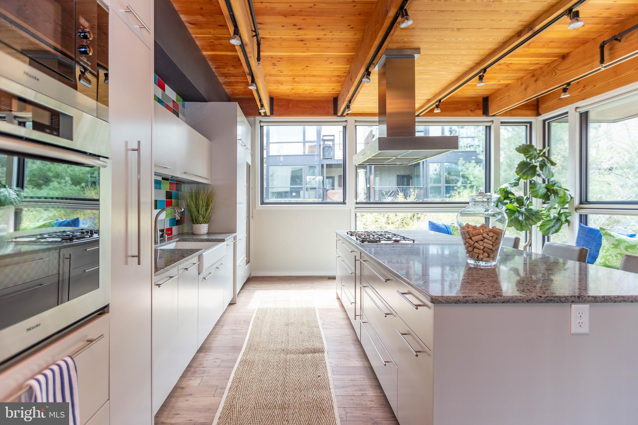 2074 Eric Shaefer Way Baltimore, MD 21211 - Photo 22 of 56 a kitchen with stainless steel appliances granite countertop a lot of counter space and a window
