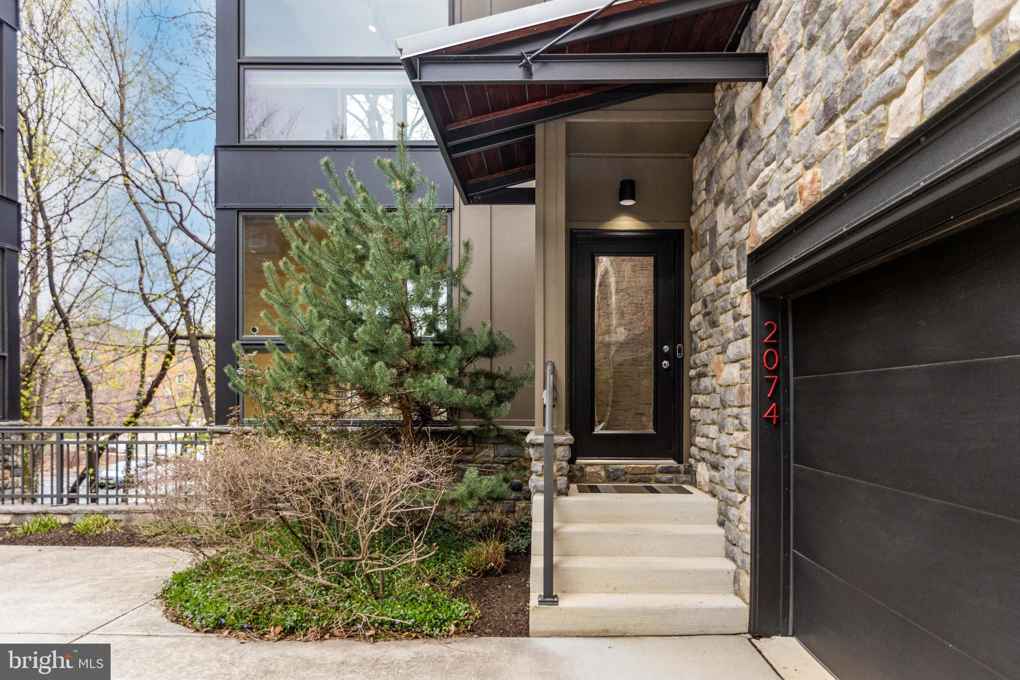 2074 Eric Shaefer Way Baltimore, MD 21211 - Photo 3 of 56 a front view of a house with a yard