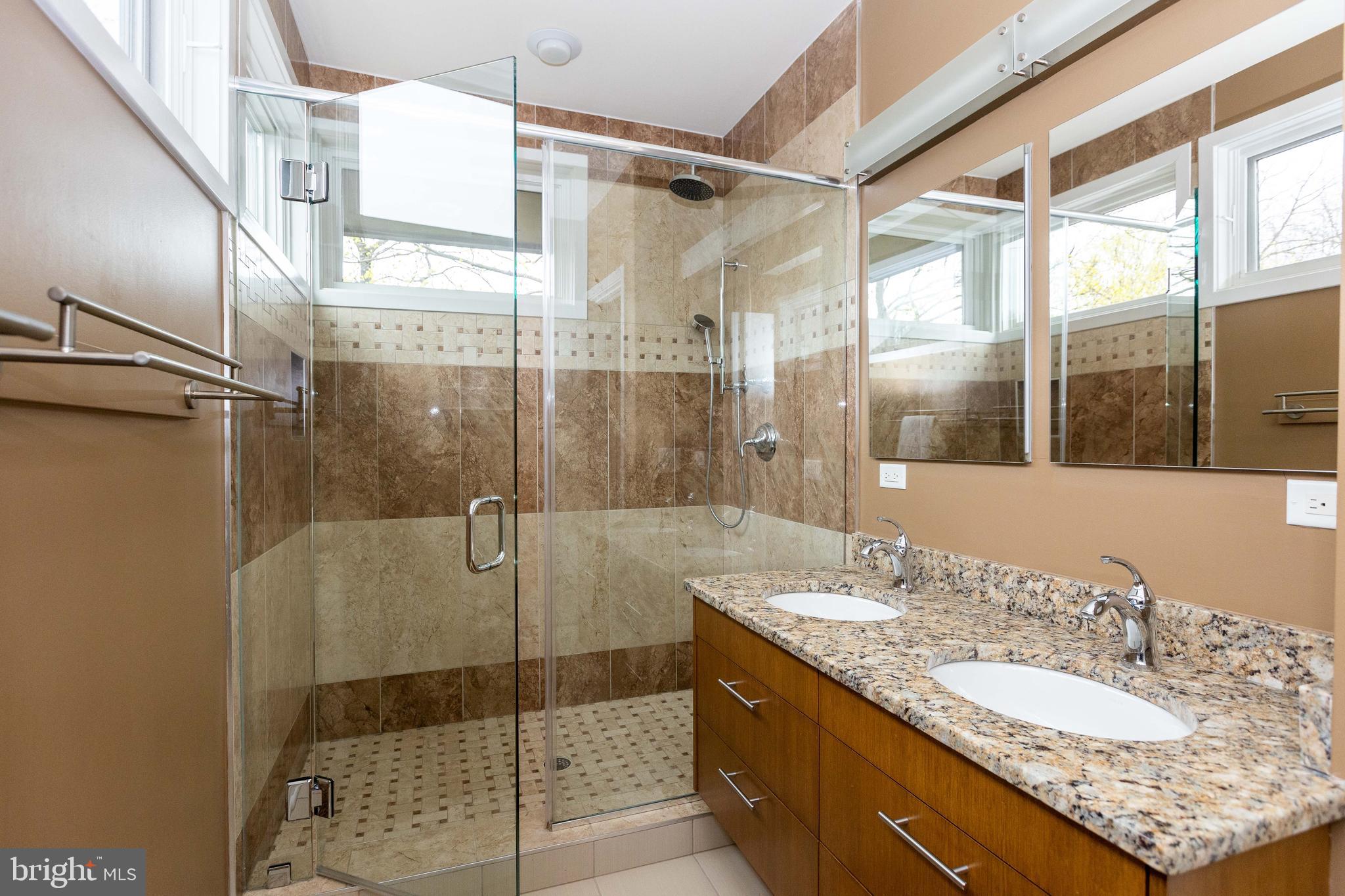 2074 Eric Shaefer Way Baltimore, MD 21211 - Photo 32 of 56 a bathroom with a granite countertop shower sink and mirror