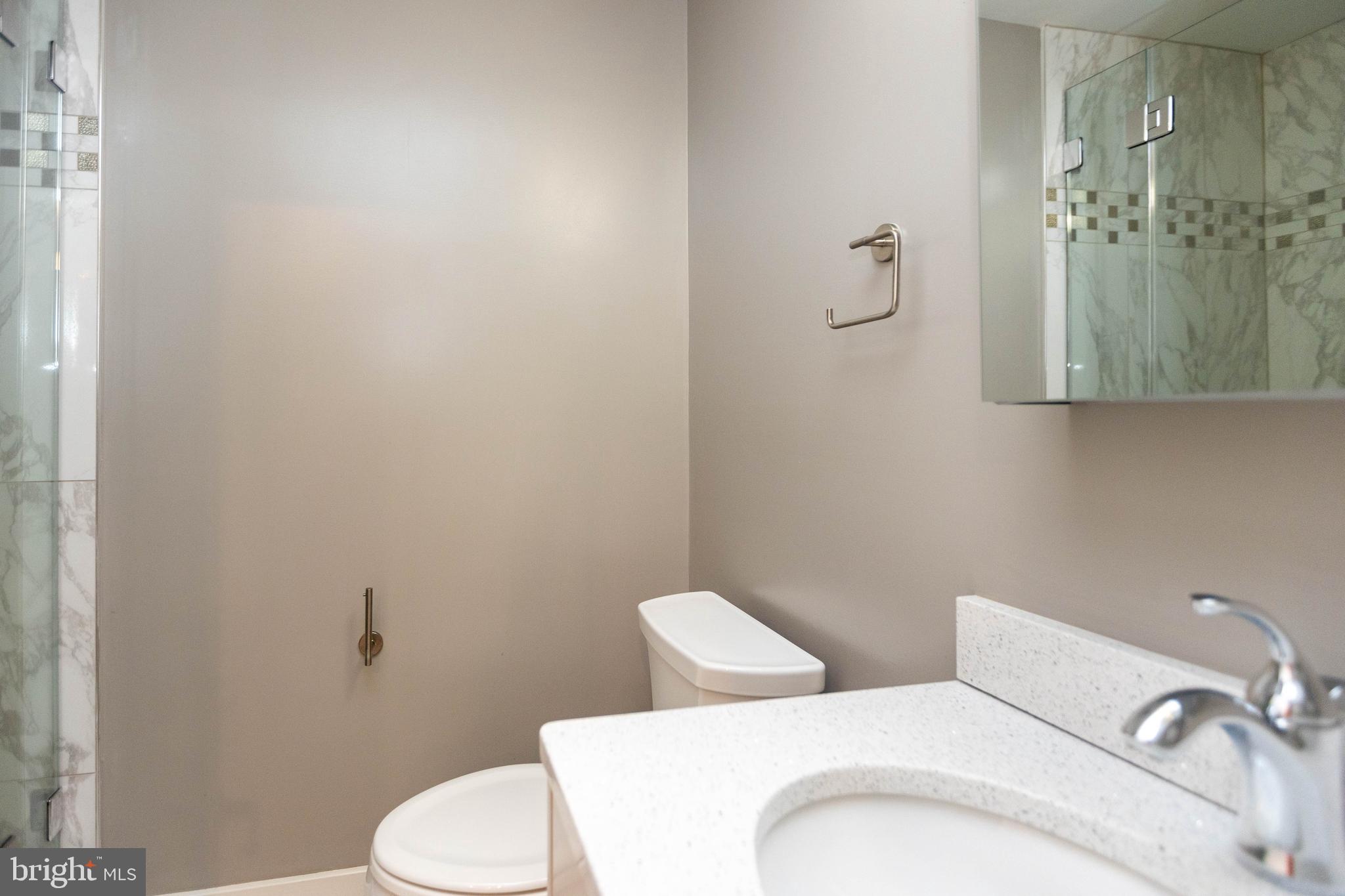 2074 Eric Shaefer Way Baltimore, MD 21211 - Photo 48 of 56 a white toilet sitting next to a bathroom sink