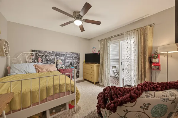 a bedroom with a bed a flat screen tv and a walk in closet