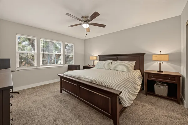 a bedroom with a bed and a ceiling fan