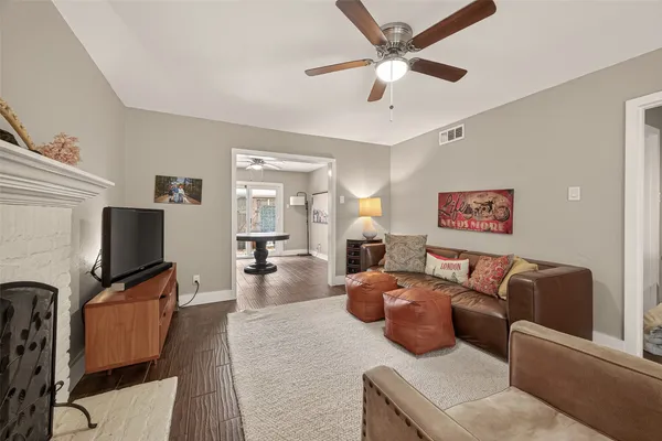 a living room with furniture a fireplace and a flat screen tv