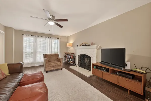 a living room with furniture a flat screen tv and a fireplace