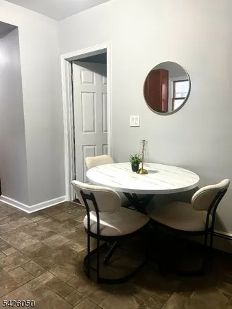 a view of a dining room with a table and chairs