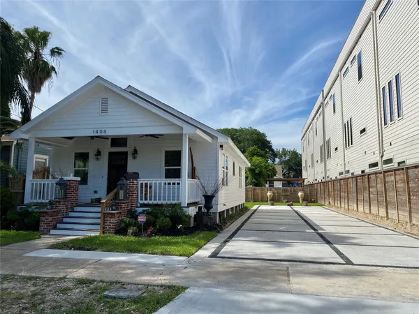 a front view of a house with a garden and plants