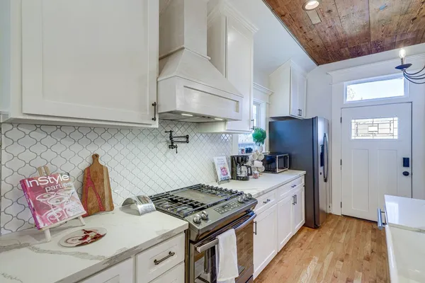 a kitchen with a stove and a refrigerator