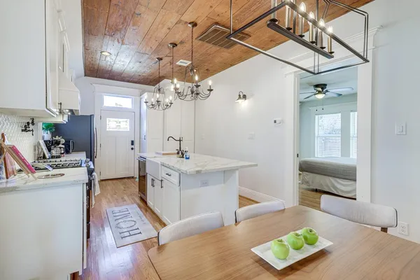 a large white kitchen with a large window