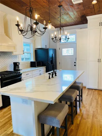 a kitchen with a table and a chandelier