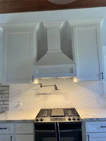 a stove top oven sitting inside of a kitchen