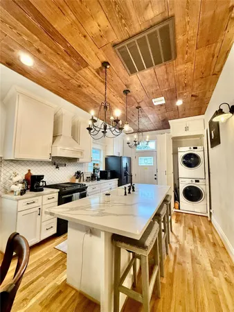 a kitchen with a sink a stove and cabinets