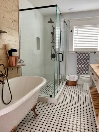 a bathroom with a bathtub and a shower