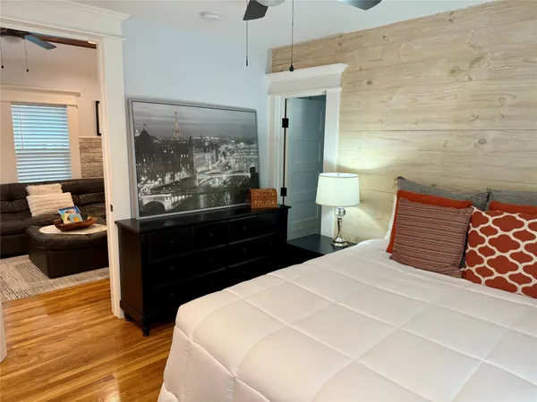 a bedroom with a bed and wooden floor