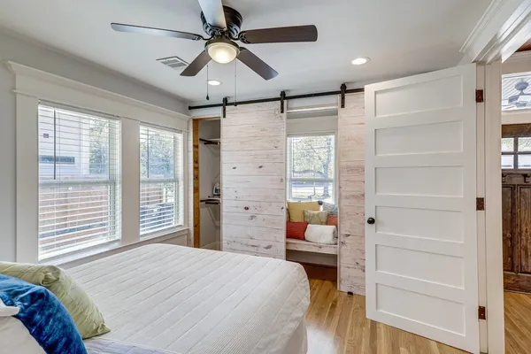 a bedroom with a bed and large window