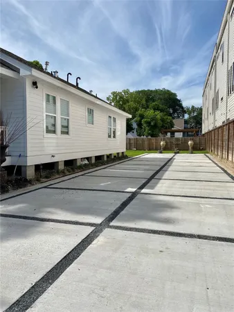 a view of a patio with table and chairs and wooden fence