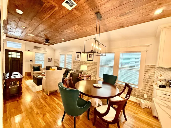 a kitchen with a table chairs and a dining table