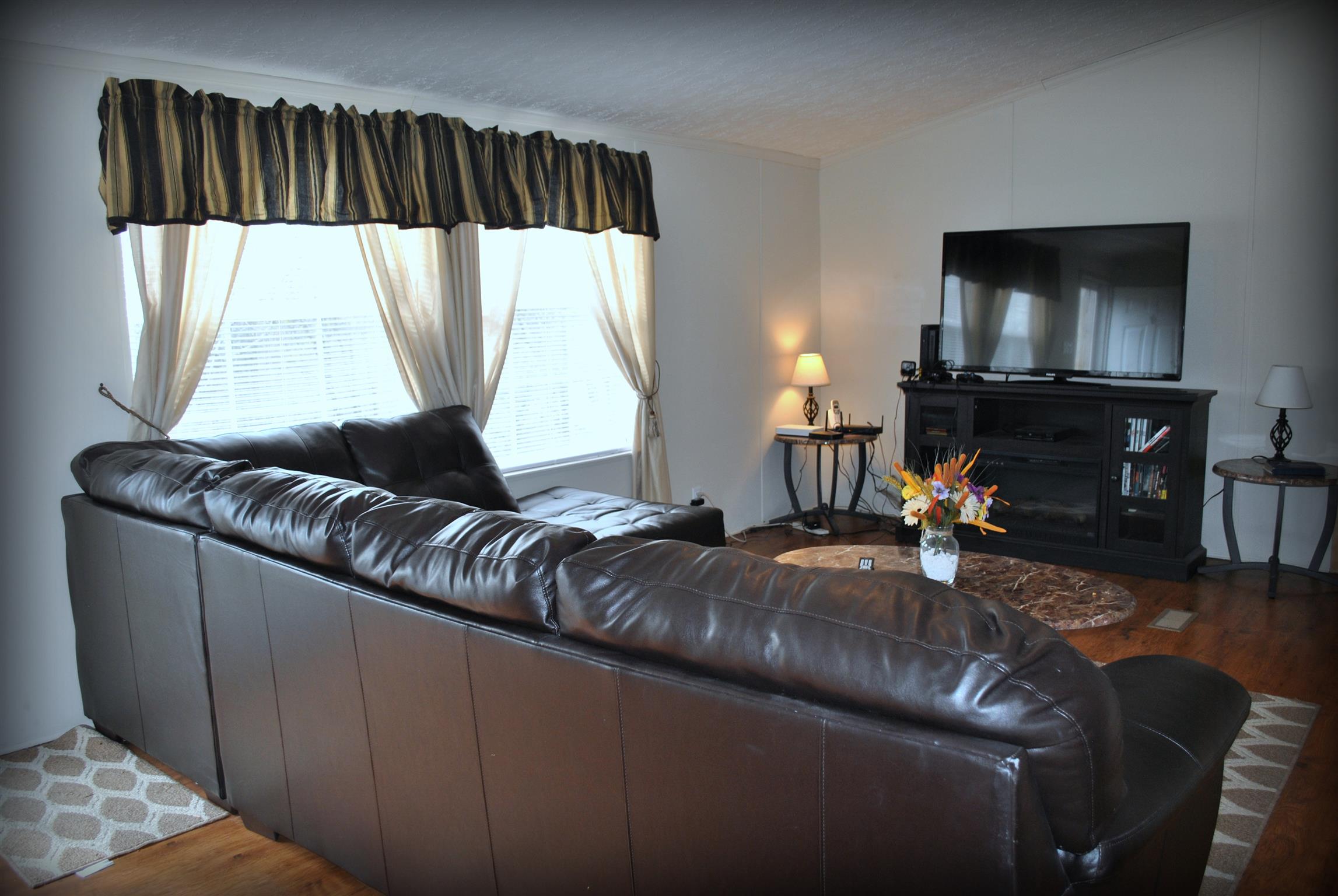 812 Dale Ridge Road Dowelltown, TN 37059 - Photo 11 of 21 a living room with a couch and a flat screen tv