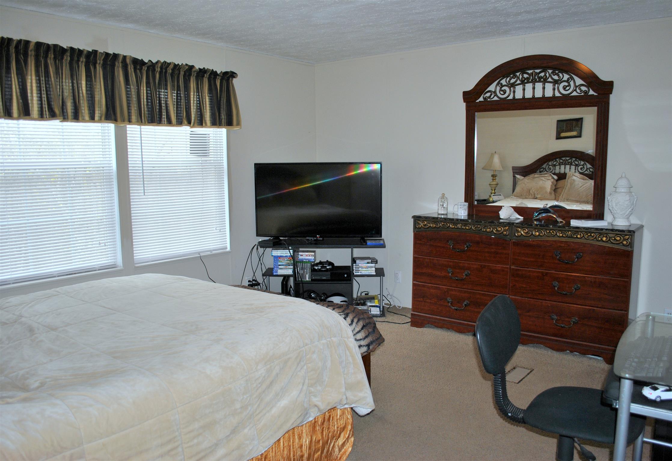 812 Dale Ridge Road Dowelltown, TN 37059 - Photo 13 of 21 a bedroom with a bed and a flat screen tv