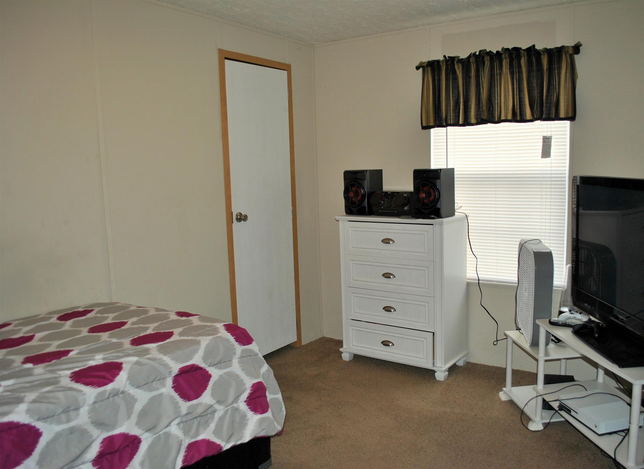 812 Dale Ridge Road Dowelltown, TN 37059 - Photo 15 of 21 a bedroom with a bed and a chair