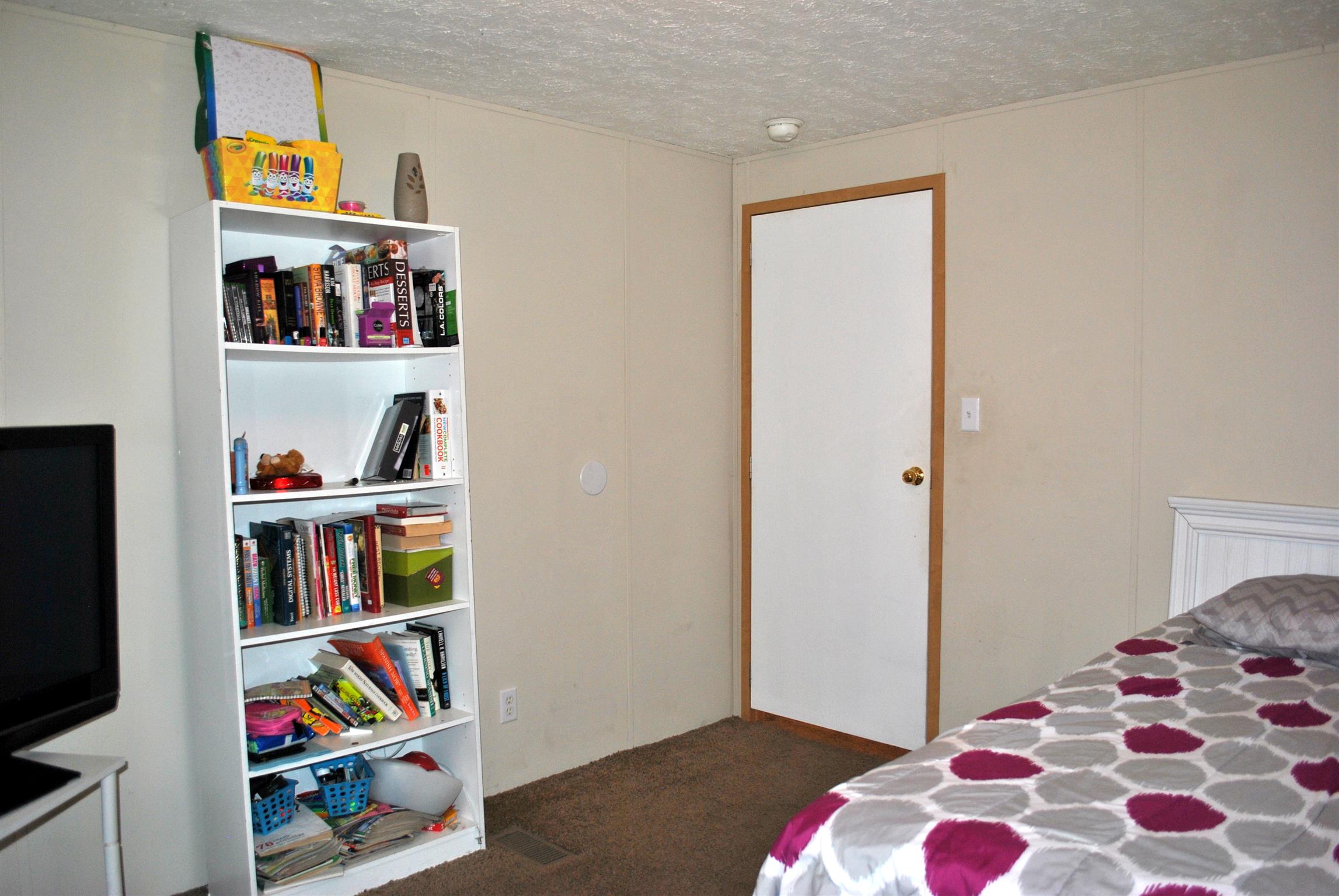 812 Dale Ridge Road Dowelltown, TN 37059 - Photo 16 of 21 a bedroom with furniture and a book shelf