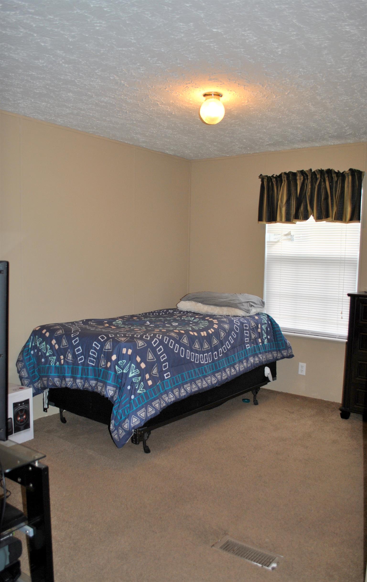 812 Dale Ridge Road Dowelltown, TN 37059 - Photo 17 of 21 a bedroom with a bed and dresser