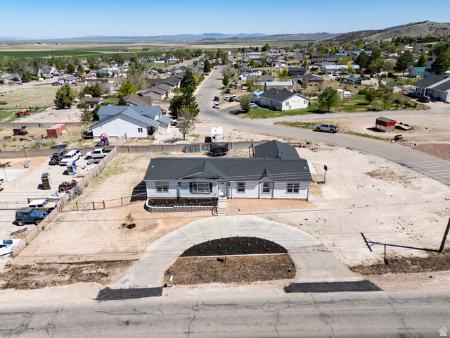 1637 East Midvalley Road Enoch, UT 84721 - Photo 41 of 48 Single-story residence featuring light-colored siding, a dark shingle roof, and white window trim