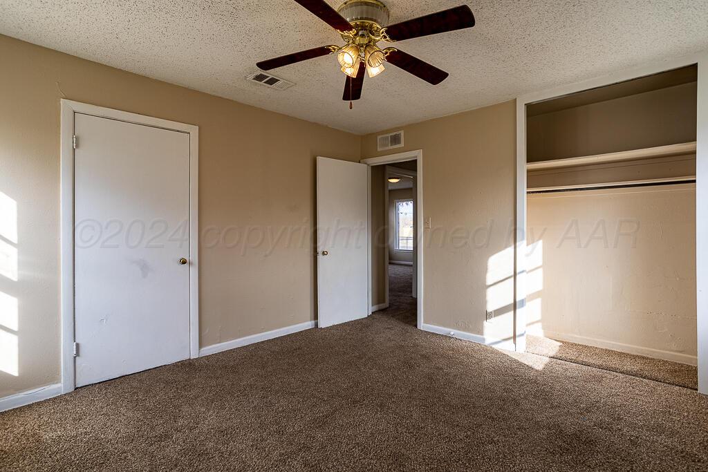 4302 South Jackson Street Amarillo, TX 79110 - Photo 11 of 16 a view of empty room with windows and ceiling fan