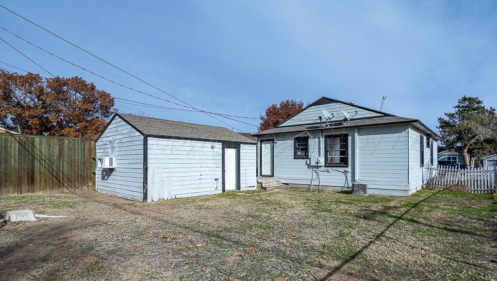 4302 South Jackson Street Amarillo, TX 79110 - Photo 14 of 16 a front view of a house with a yard and garage