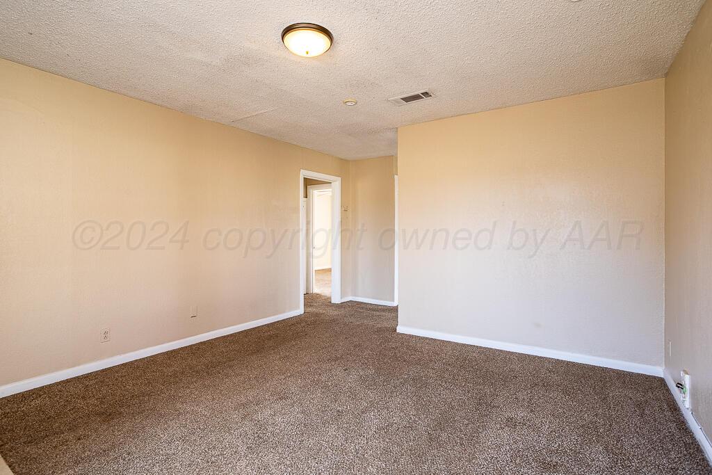4302 South Jackson Street Amarillo, TX 79110 - Photo 2 of 16 an empty room with a empty space and a window