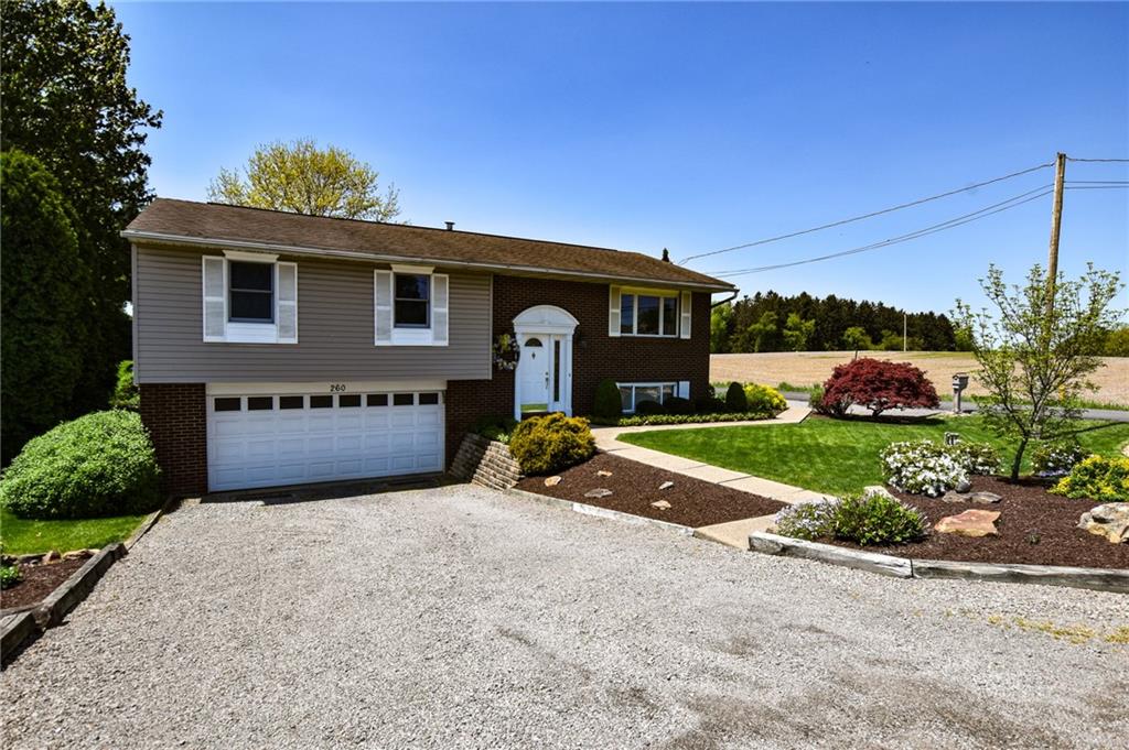 260 Fisher Road Saxonburg, PA 16056 - Photo 2 of 19 a front view of a house with a yard and garage